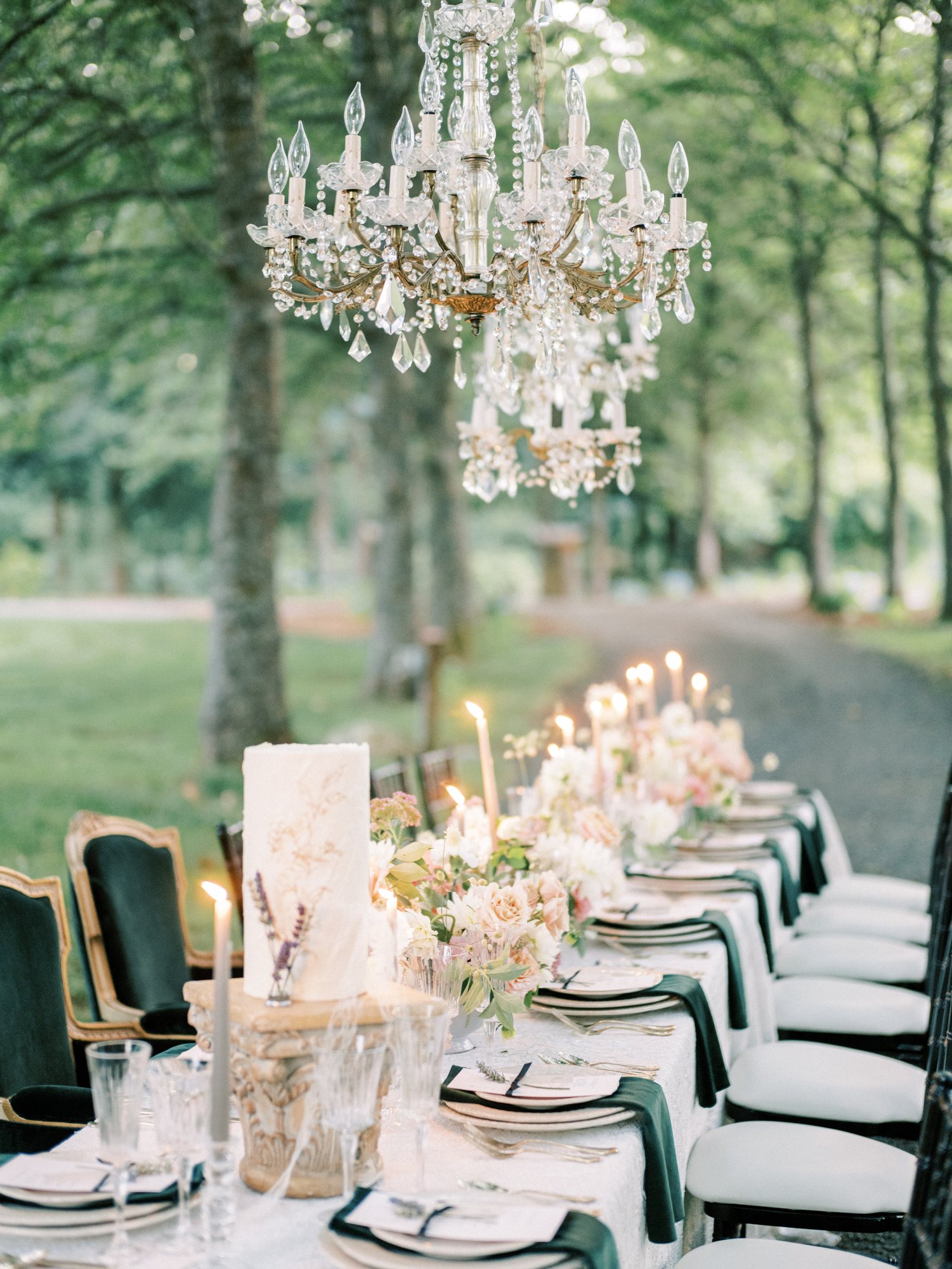 Candlelit reception tablescape under a floral chandelier