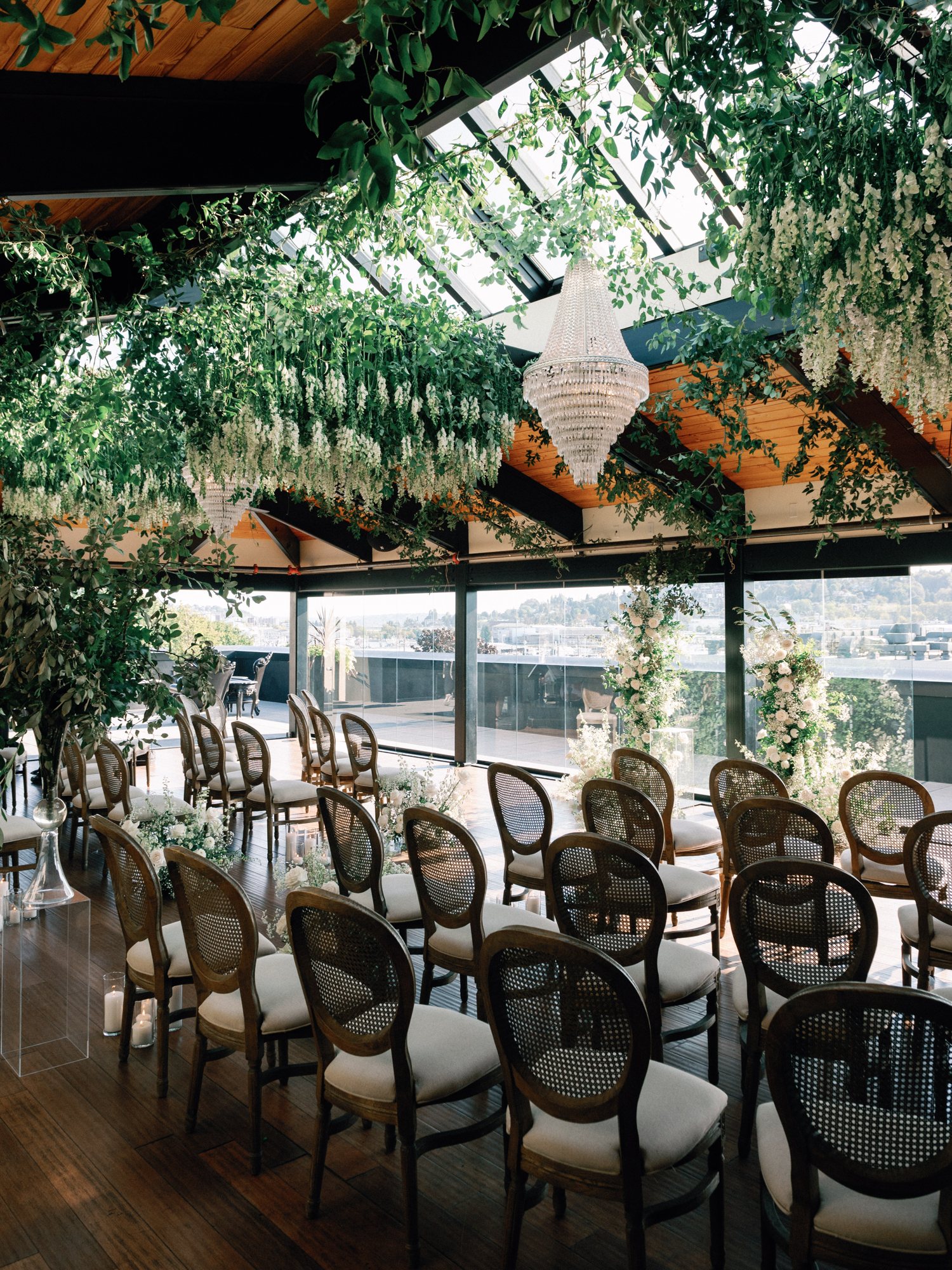 Reception dining beneath a hanging greenery installation